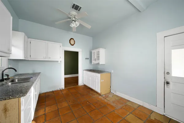 a kitchen with cabinets and window