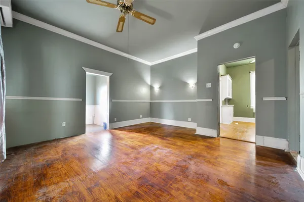 a view of empty room with wooden floor