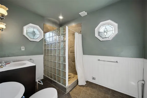 a bathroom with a toilet a sink and a mirror
