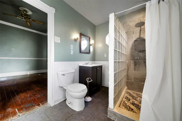 a bathroom with a toilet and a shower