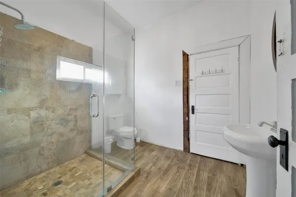 a bathroom with a shower and a toilet