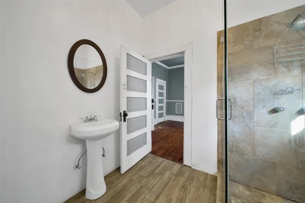 a bathroom with a sink a toilet and a shower