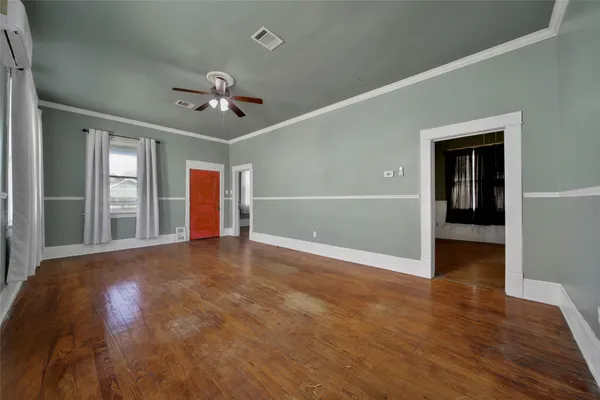 wooden floor in an empty room with a window