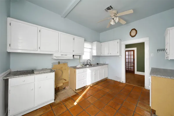 a kitchen with stainless steel appliances granite countertop a stove cabinets and wooden floor