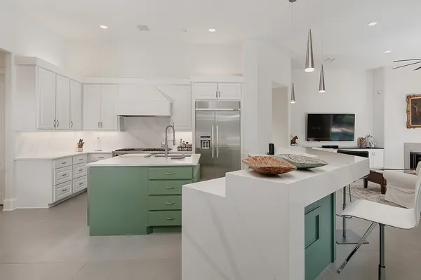 a kitchen that has a sink and a stove in it