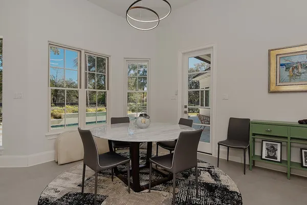 a view of a dining room with a table and chairs