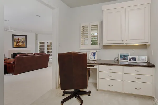 a view of cabinets a window and a chair