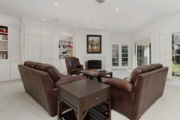 a living room with furniture a flat screen tv and a window