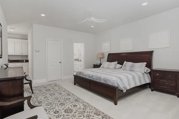 a spacious bedroom with a bed and a couch