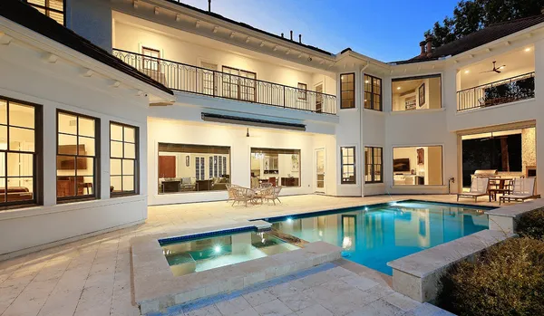 a view of a house with swimming pool and sitting area