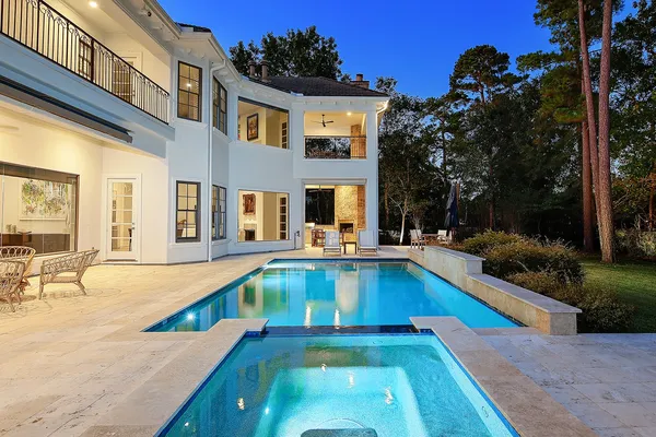 a view of a house with swimming pool and sitting area