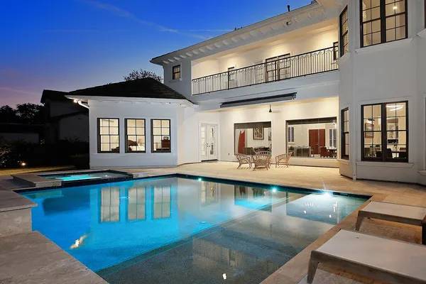 a view of a house with swimming pool and sitting area