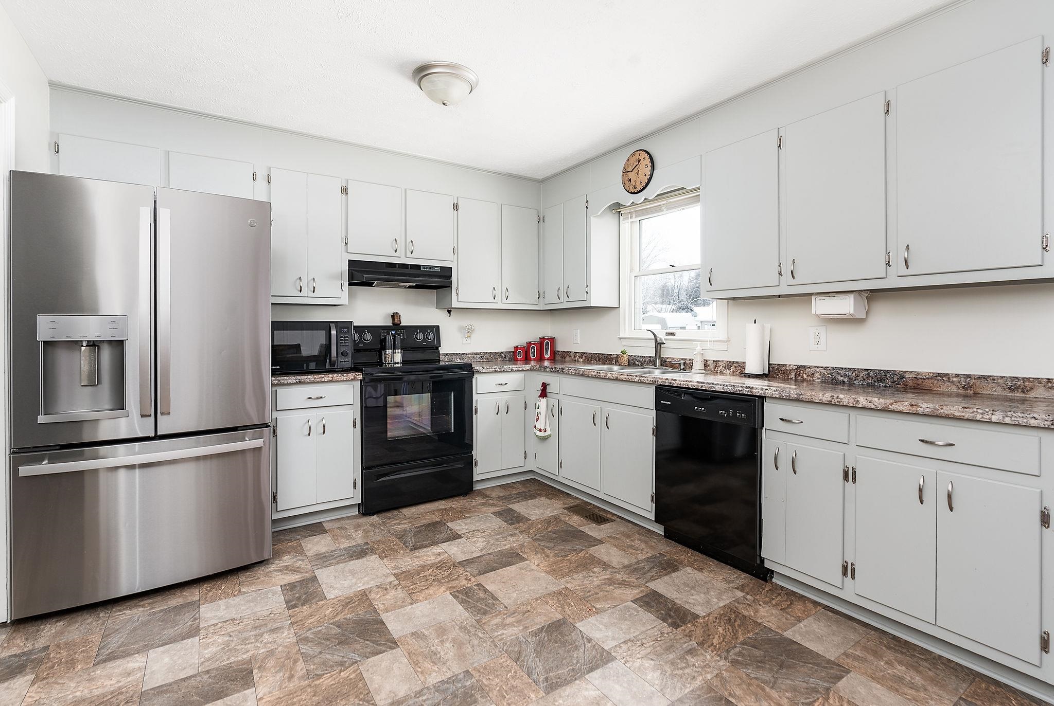 99 Harvest Road Waynesboro, VA 22980 - Photo 2 of 36 a kitchen with granite countertop white cabinets and stainless steel appliances