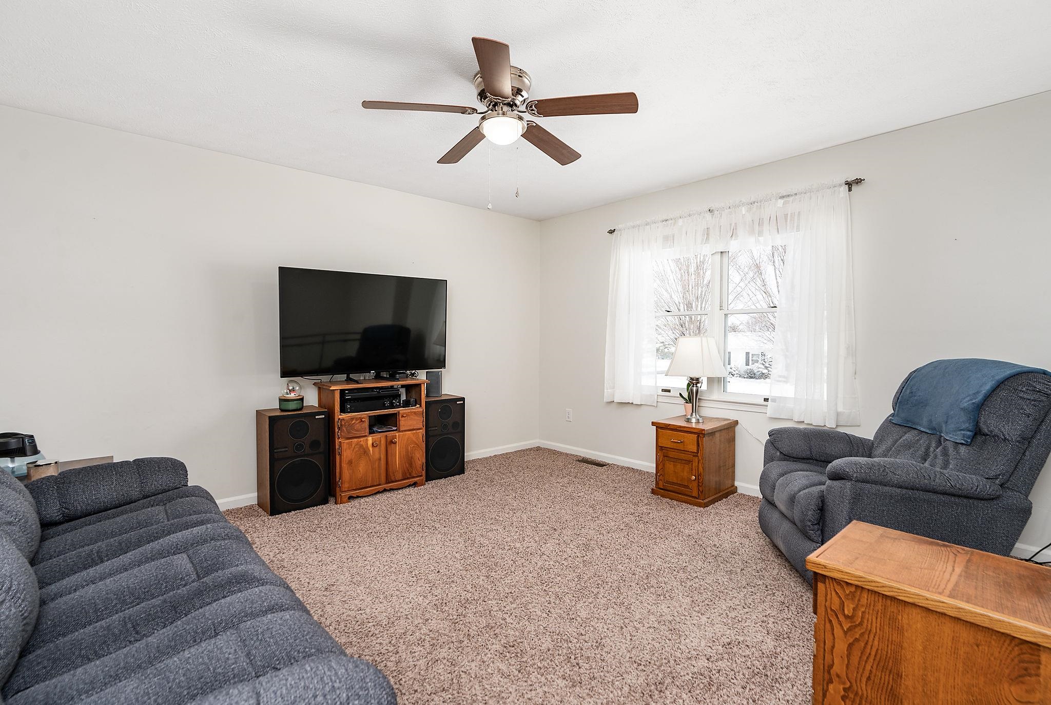 99 Harvest Road Waynesboro, VA 22980 - Photo 8 of 36 a living room with furniture and a flat screen tv