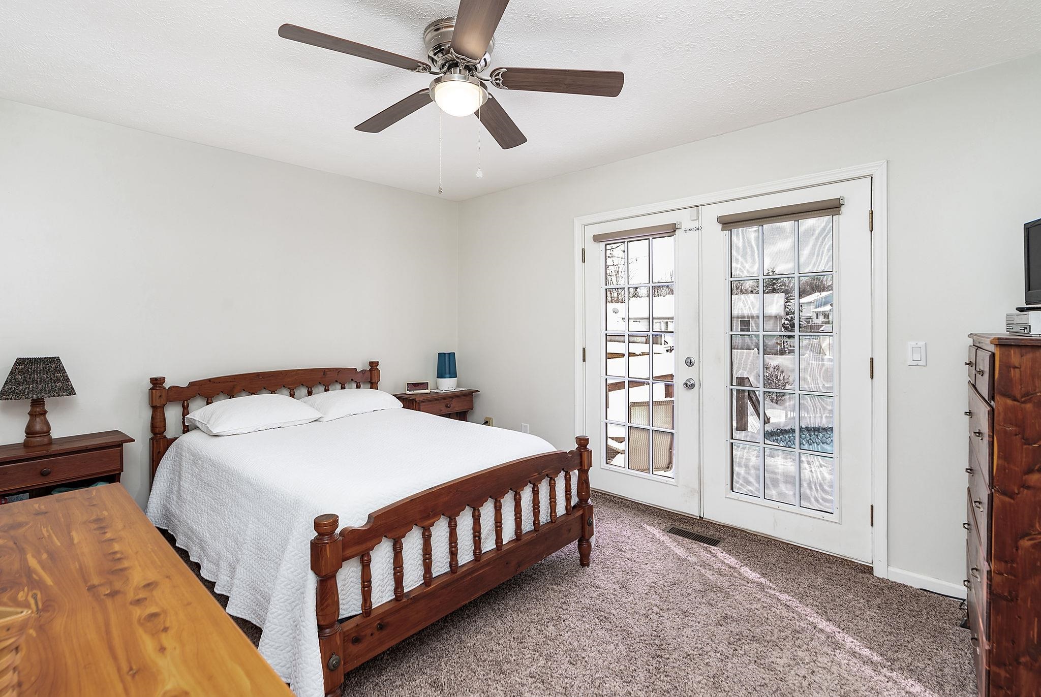 99 Harvest Road Waynesboro, VA 22980 - Photo 10 of 36 a bedroom with a large bed and a chandelier