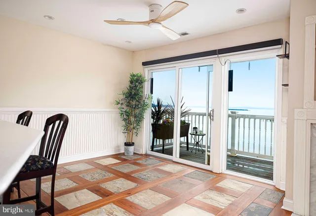 a view of a porch with a table and chairs
