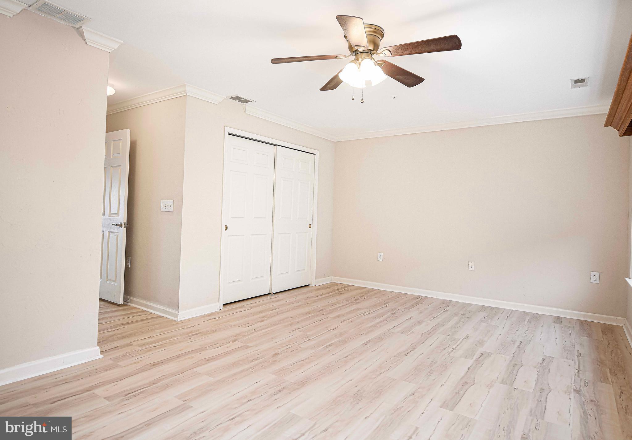 203 Pointe Way, Unit 53 Havre de Grace, MD 21078 - Photo 15 of 29 an empty room with wooden floor fan and windows