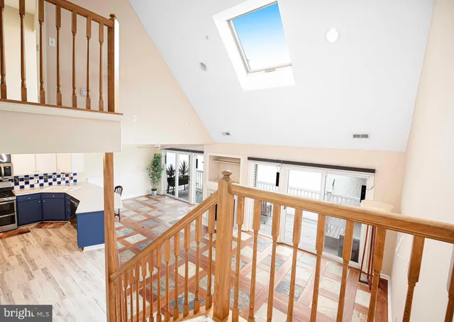 a view of a hallway with furniture and staircase