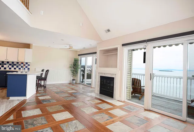 a view of livingroom with furniture fireplace and window