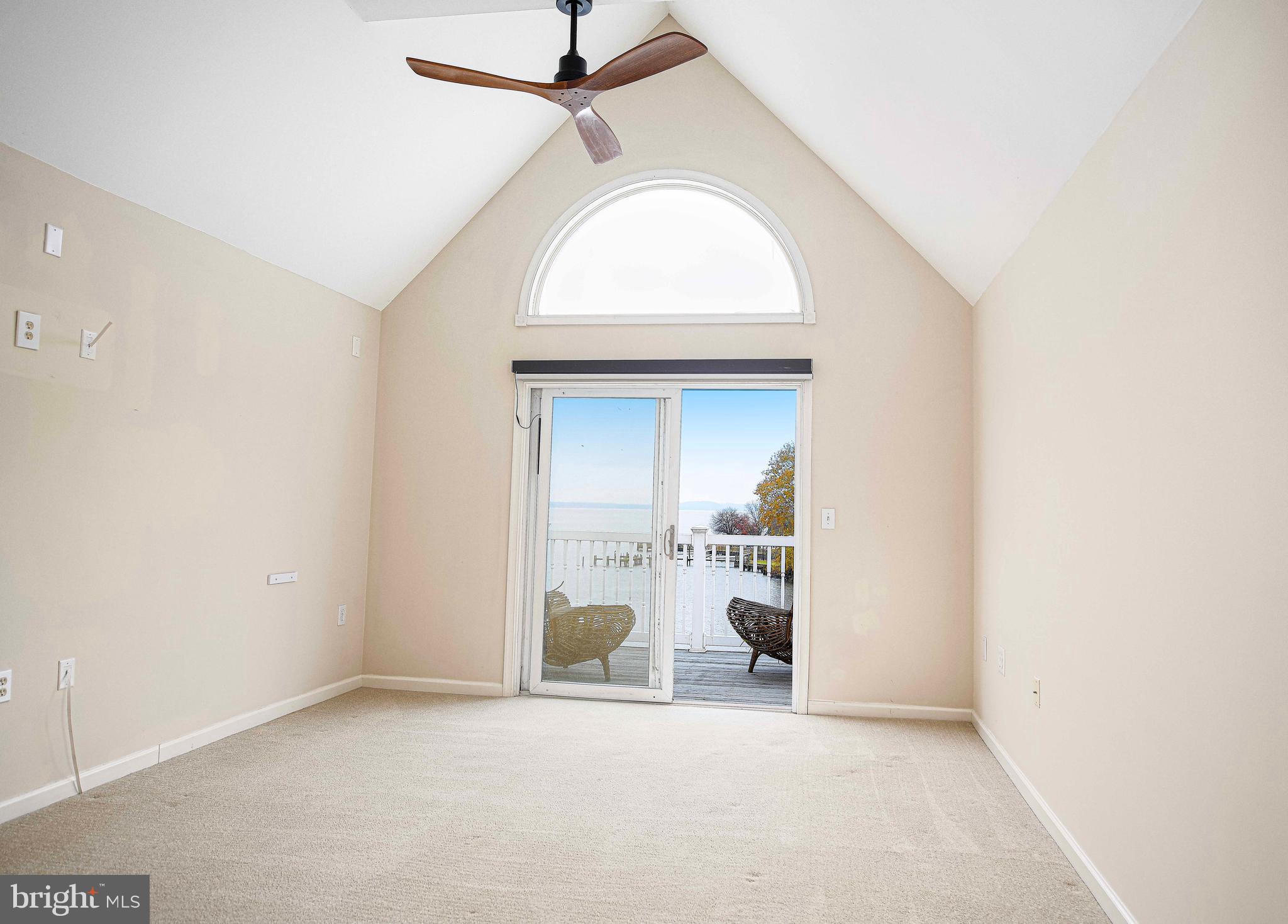 203 Pointe Way, Unit 53 Havre de Grace, MD 21078 - Photo 3 of 29 an empty room with a fireplace and a chandelier fan