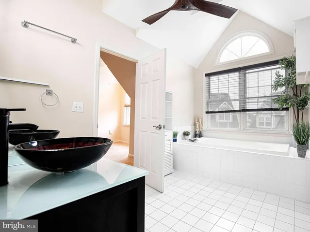 a living room with a table chairs and a window