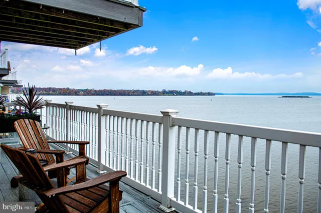 a view of a balcony with wooden floor and outdoor seating