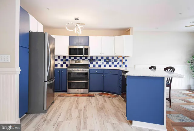 a kitchen with stainless steel appliances a refrigerator and a stove