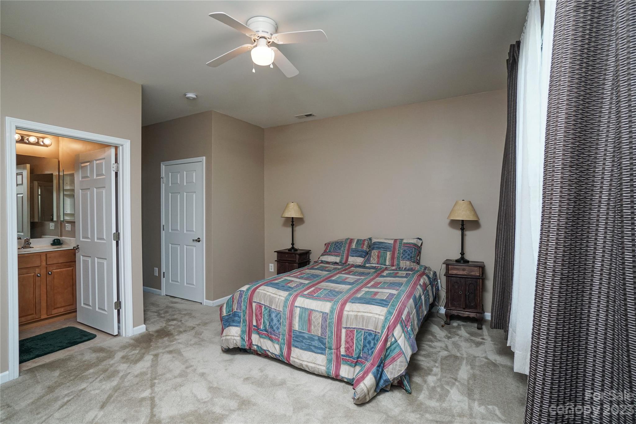 662 Amethyst Circle Fort Mill, SC 29708 - Photo 11 of 34 a bedroom with a bed and a chandelier