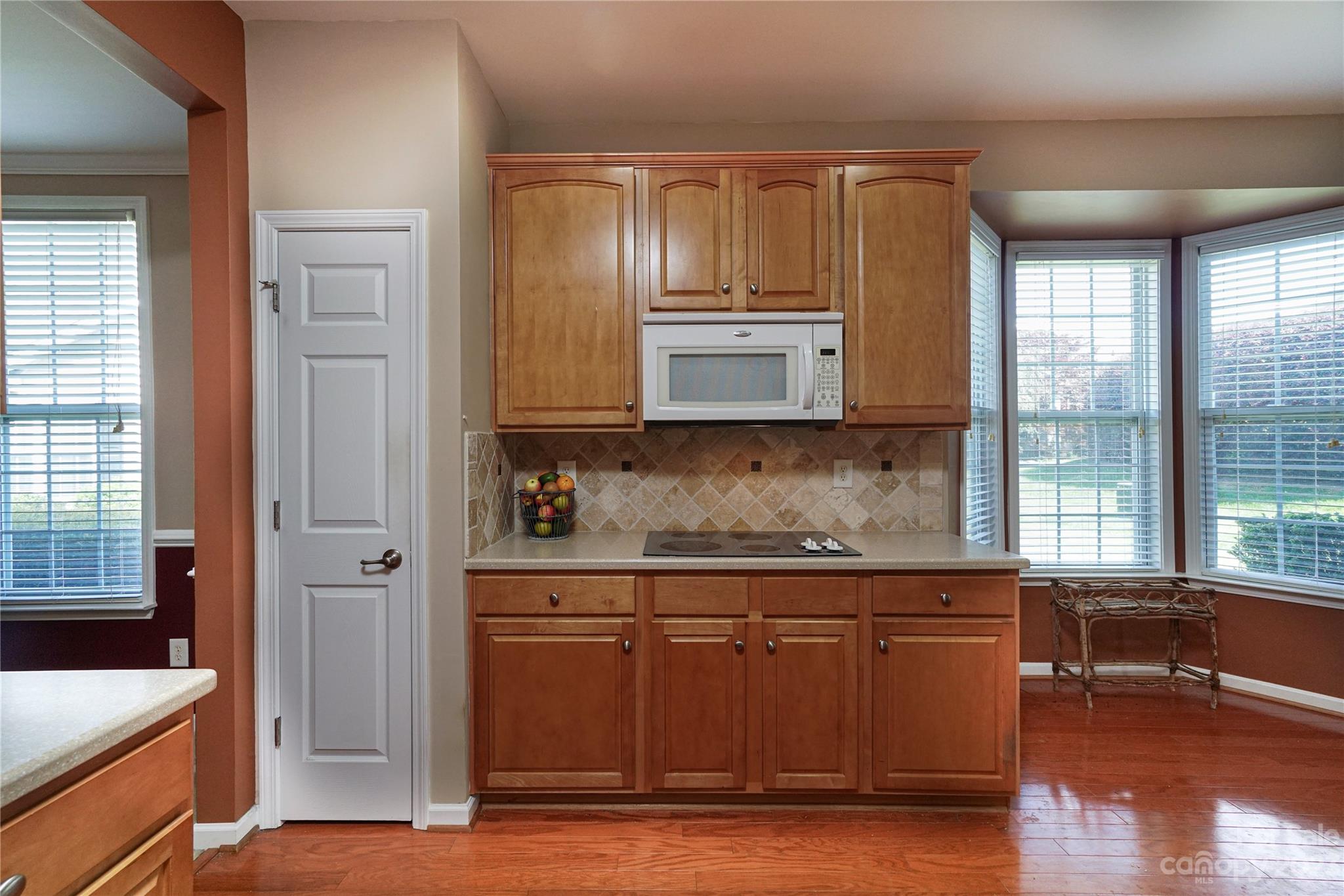 662 Amethyst Circle Fort Mill, SC 29708 - Photo 14 of 34 a kitchen with stainless steel appliances granite countertop a stove a sink and a refrigerator with wooden floor