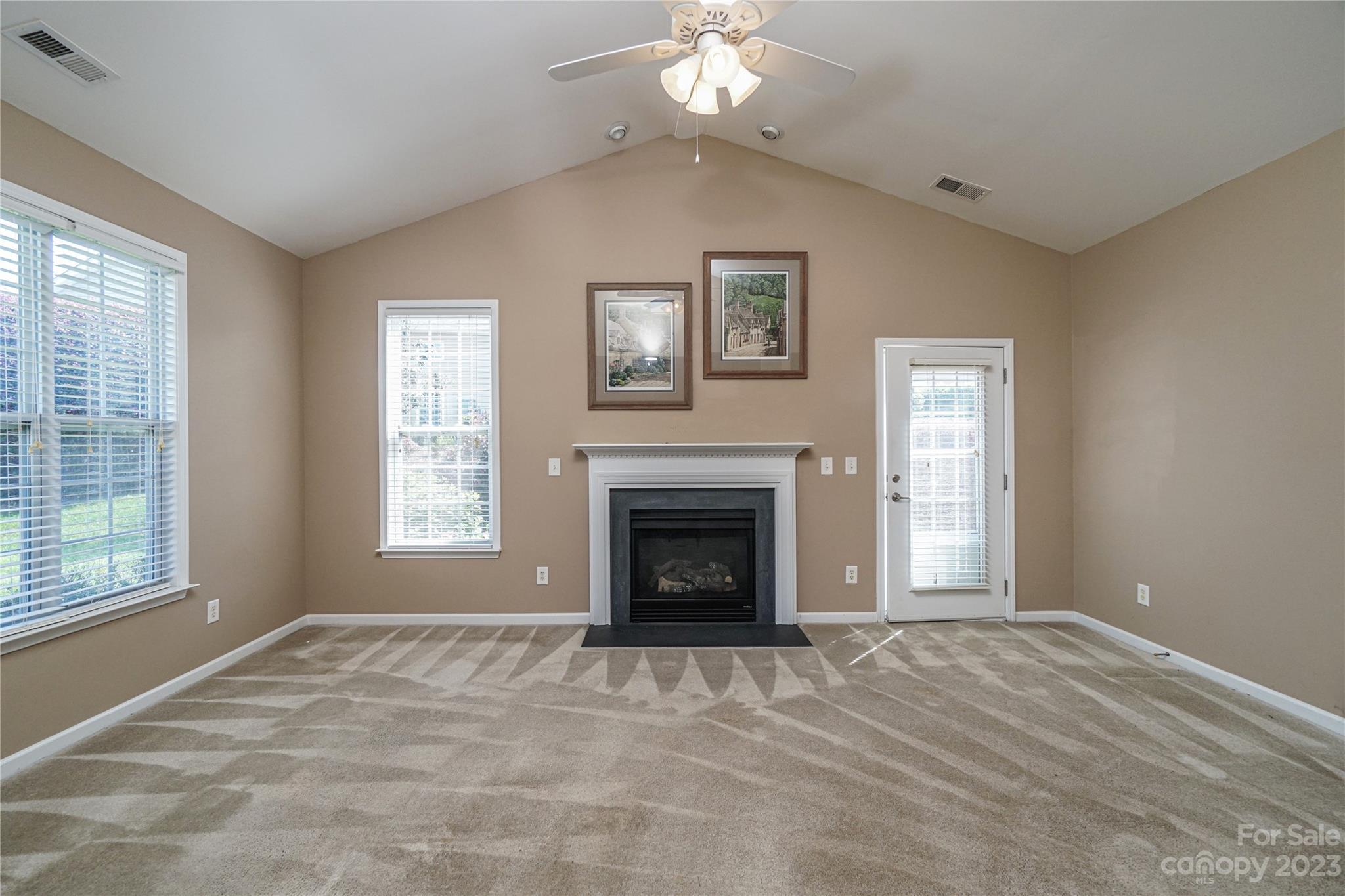 662 Amethyst Circle Fort Mill, SC 29708 - Photo 16 of 34 a view of an empty room with window fireplace and chandelier