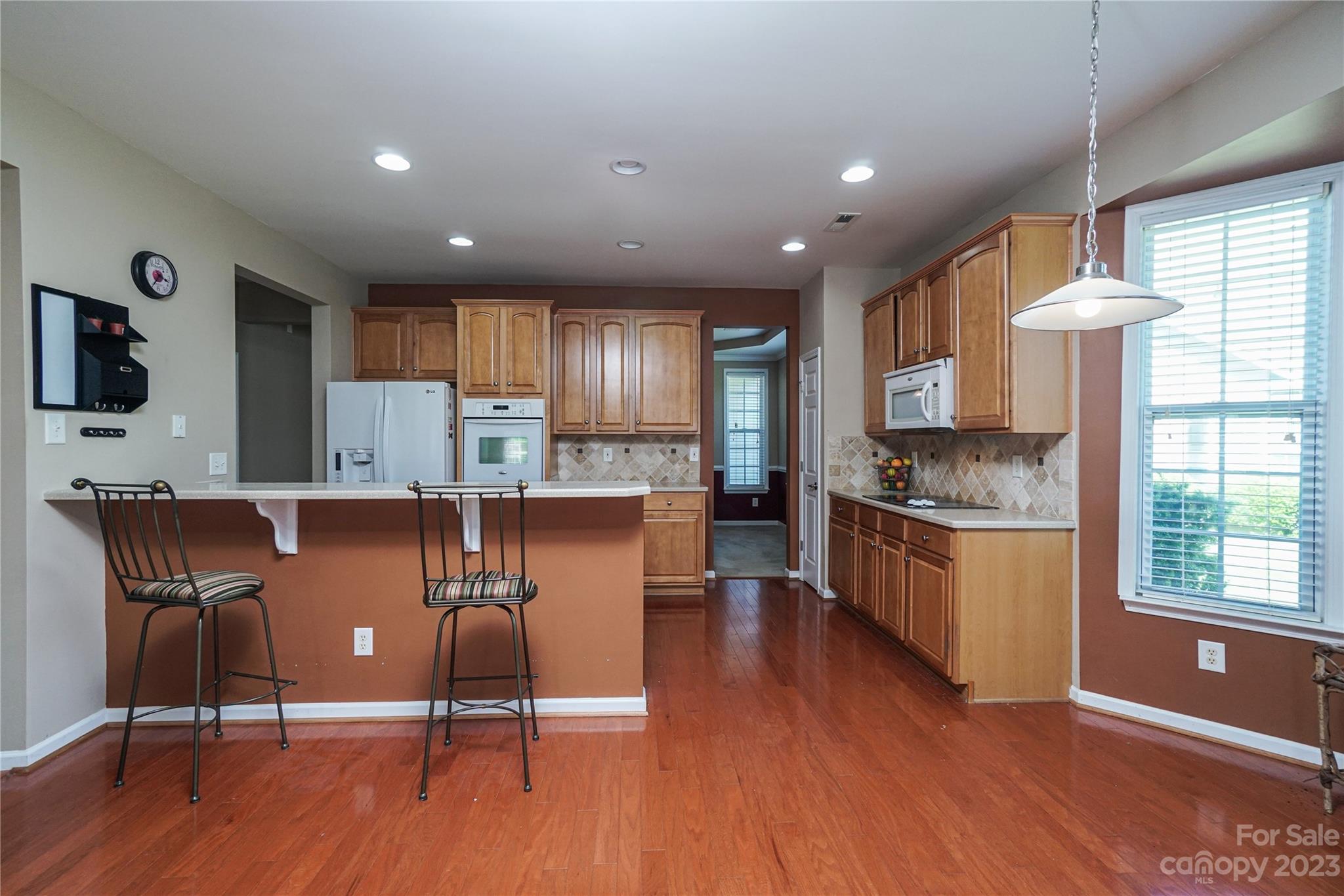 662 Amethyst Circle Fort Mill, SC 29708 - Photo 18 of 34 a kitchen with granite countertop wooden floors and white cabinets