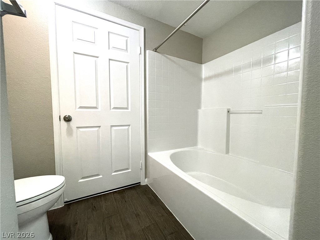 10001 Peace Way, Unit 1327 Las Vegas, NV 89147 - Photo 16 of 21 A well-maintained bathroom with a clean, functional tub and rich flooring offers daily comfort.