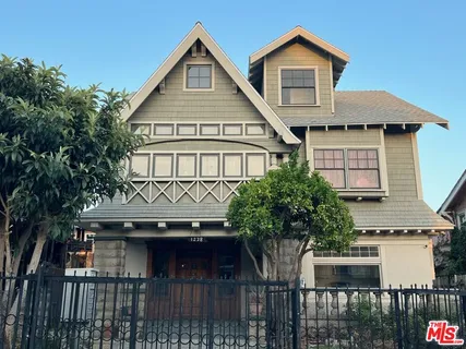 a front view of a house with a garden and plants