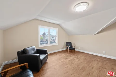 a view of house with backyard and sitting area