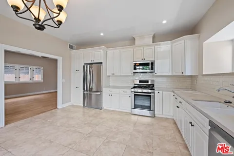 a bathroom with a sink toilet vanity and shower
