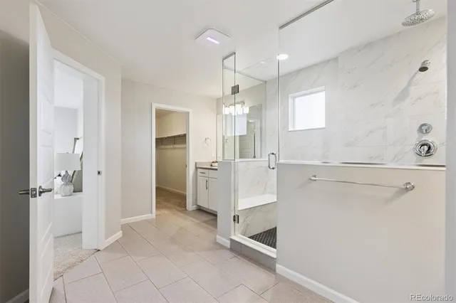 a view of a kitchen with white cabinets and wooden floor