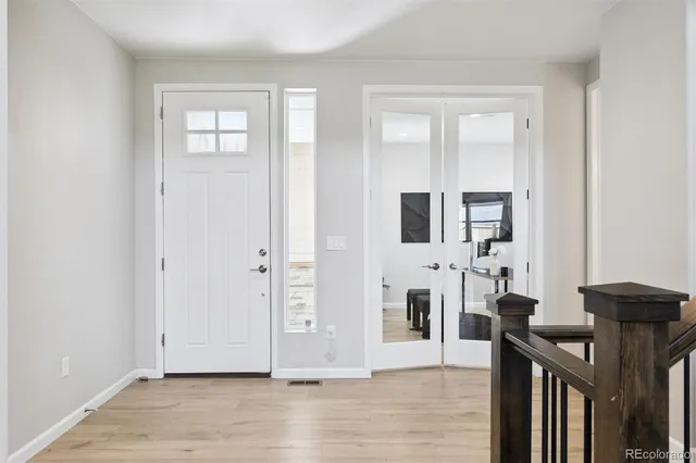 a view of a livingroom with wooden floor and furniture