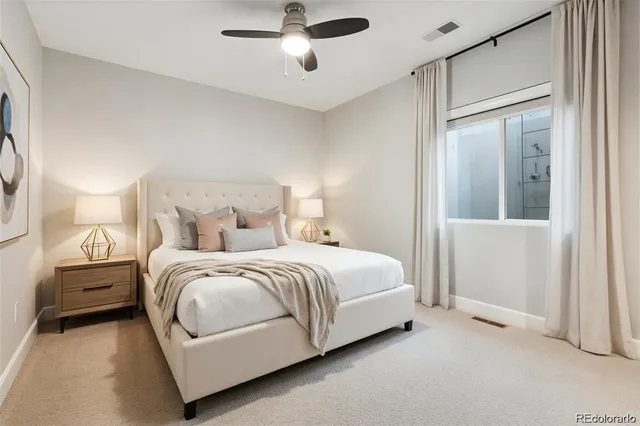 a spacious bedroom with a bed and a cabinets