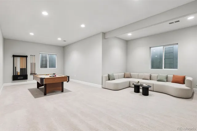a living room with furniture and white walls