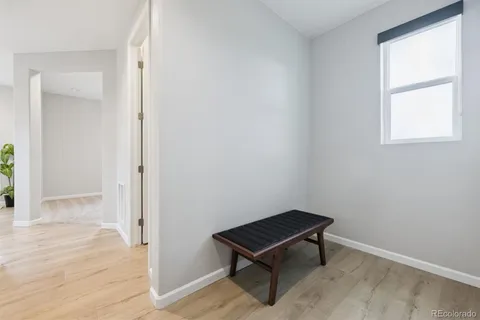 an empty room with windows and wooden floor