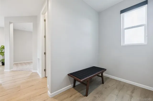 an empty room with windows and wooden floor