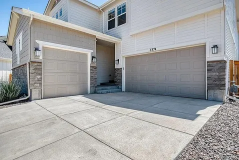 a front view of a house with a garage