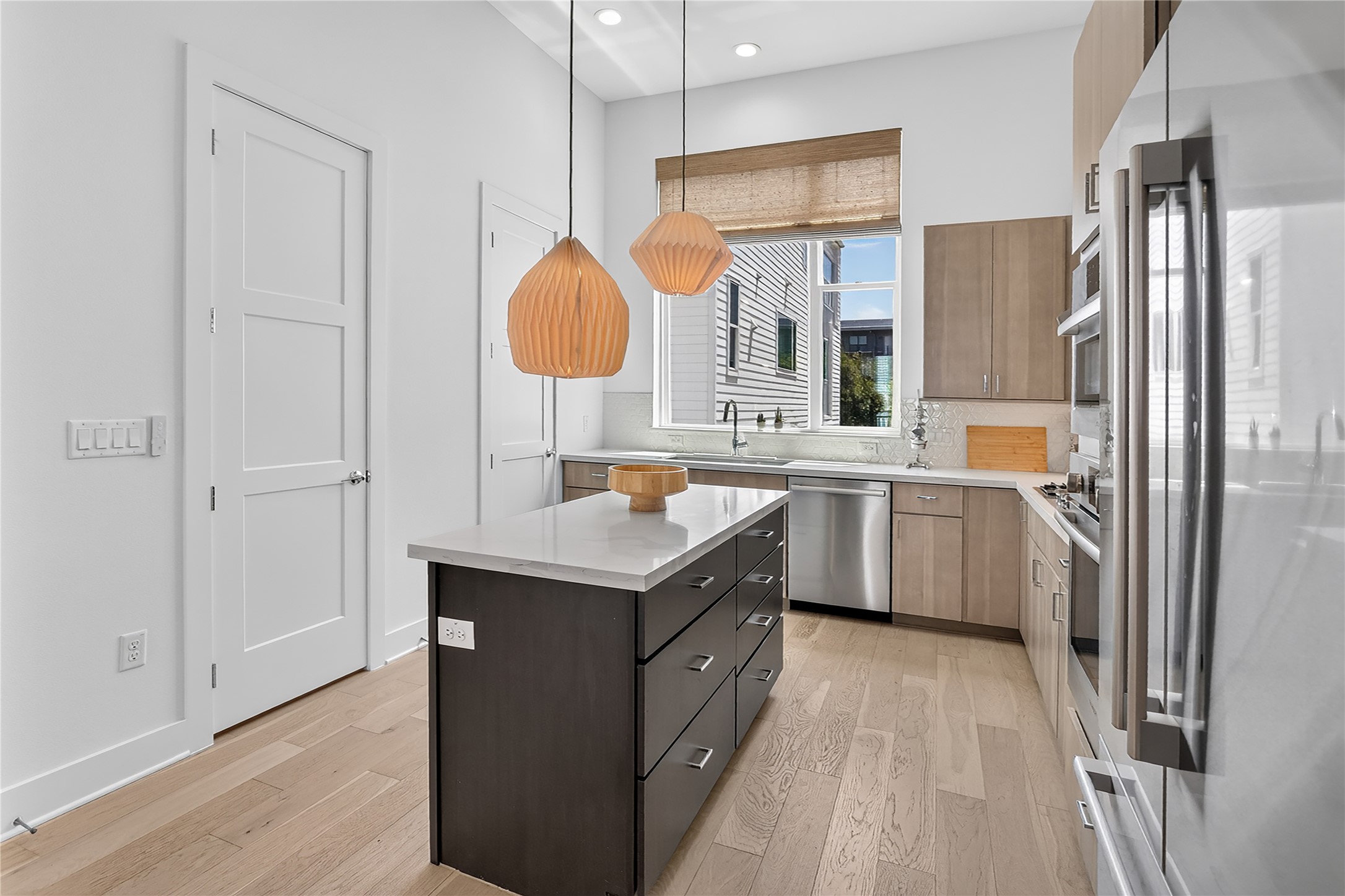 2805 McCurdy Street, Unit 14 Austin, TX 78723 - Photo 9 of 40 Culinary aspirations come alive in this well-appointed kitchen featuring light hardwood flooring and recessed lighting.
