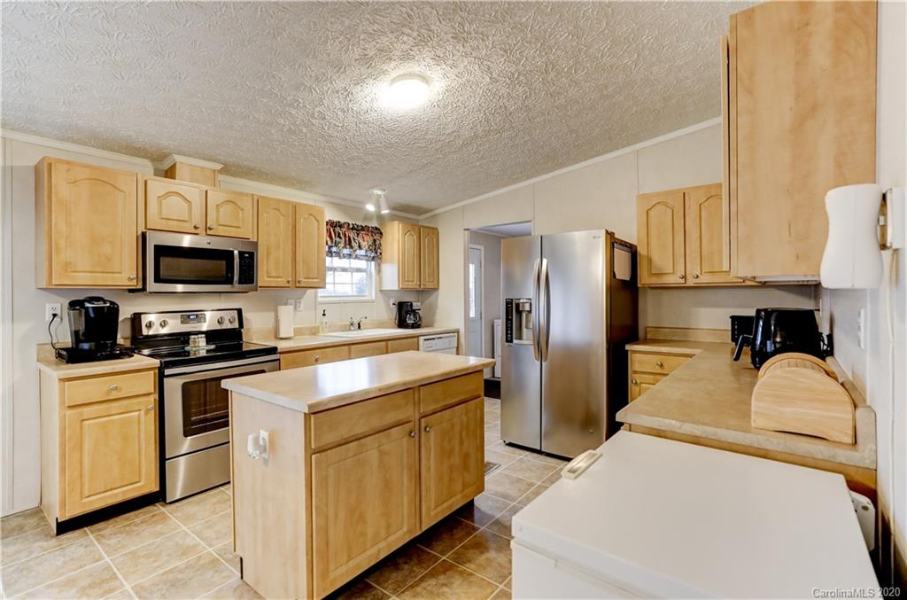 687 Fayette Road York, SC 29745 - Photo 12 of 48 a kitchen with stainless steel appliances granite countertop a refrigerator a stove top oven a sink and dishwasher