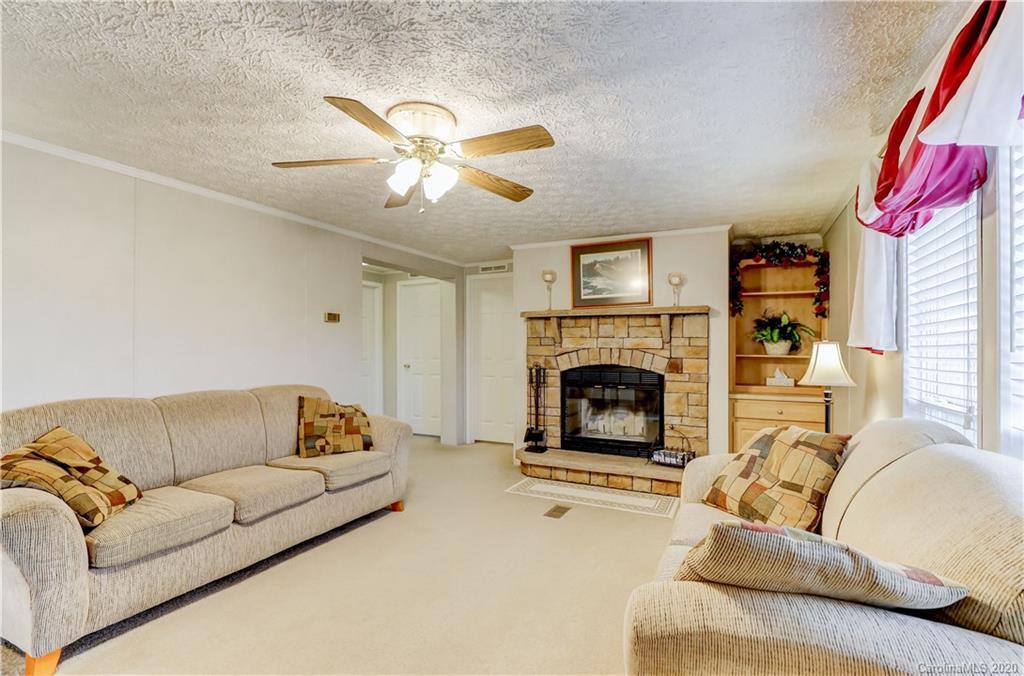 687 Fayette Road York, SC 29745 - Photo 20 of 48 a living room with furniture a fireplace and a large window