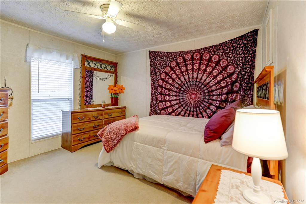 687 Fayette Road York, SC 29745 - Photo 23 of 48 a bedroom with a bed and a lamp on dresser