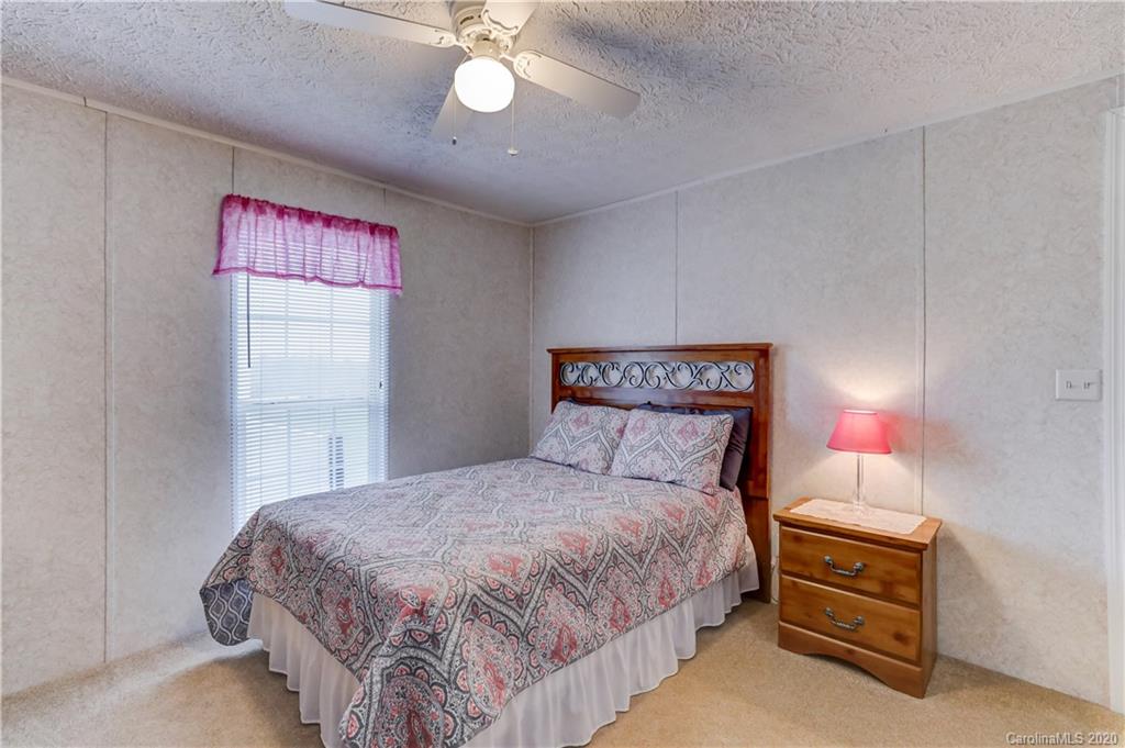 687 Fayette Road York, SC 29745 - Photo 31 of 48 a bedroom with a bed and a chandelier