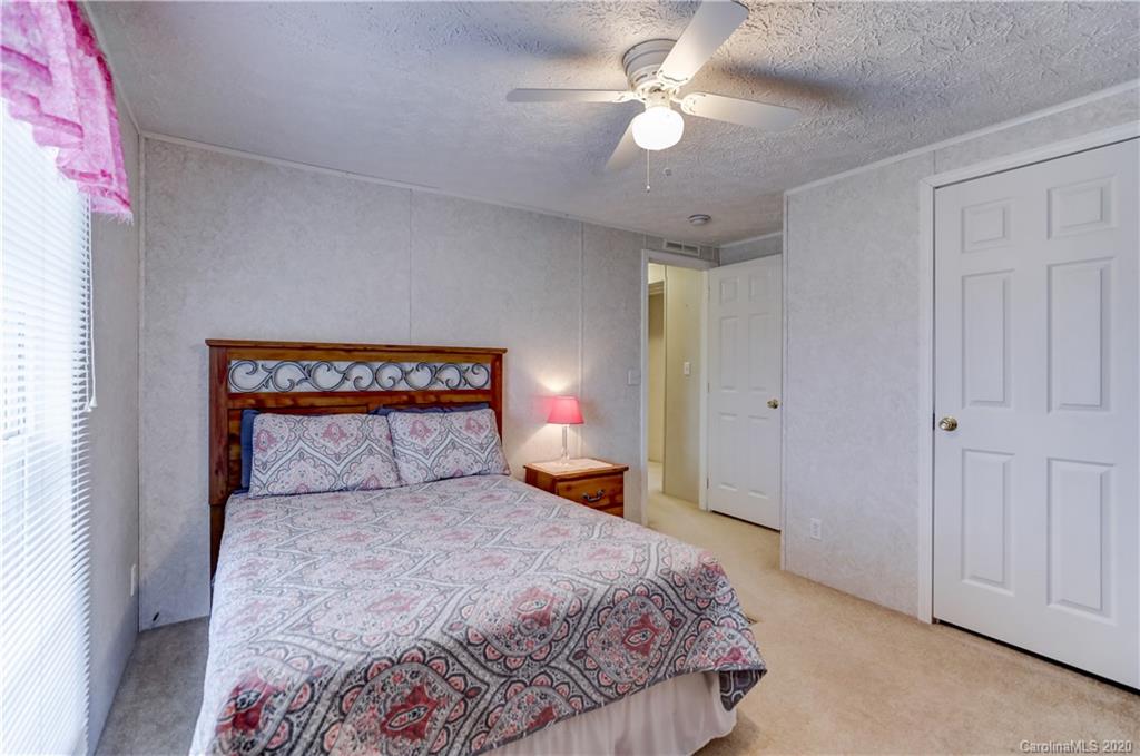 687 Fayette Road York, SC 29745 - Photo 32 of 48 a bedroom with a large bed and a chandelier