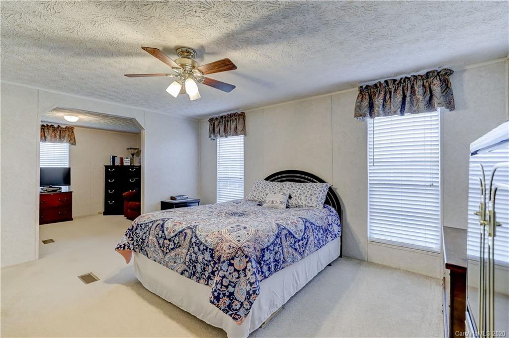 687 Fayette Road York, SC 29745 - Photo 33 of 48 a bedroom with a bed and a chandelier