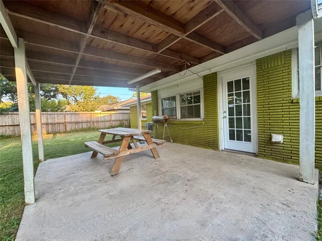 a view of a patio with a table and chairs